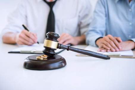 couple signing divorce papers in law office