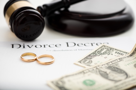 divorce decree, wedding rings, and money