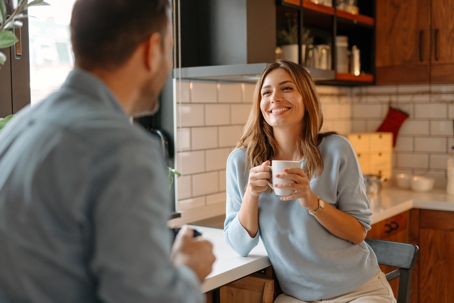 happy couple talking and drinking coffee