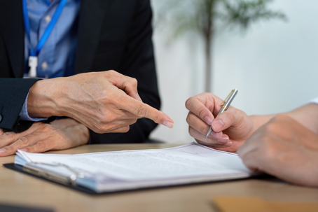 person reviewing a document with a lawyer