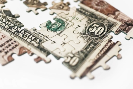 Puzzle with money symbolizing what is a QDRO