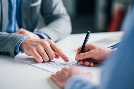 A client signing divorce documents after mediation.